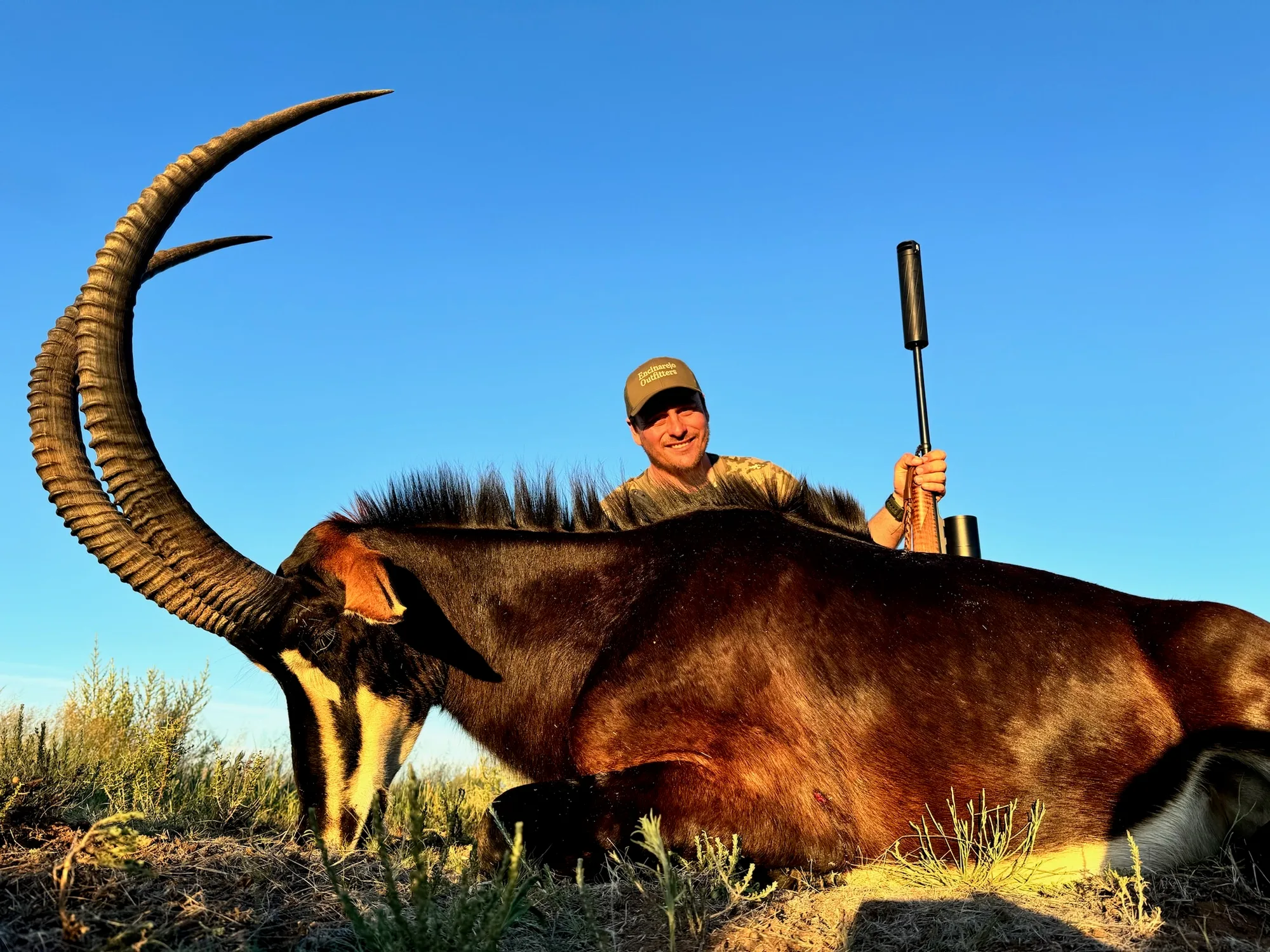 A hunter with a sable antelope taken on a South African hunt