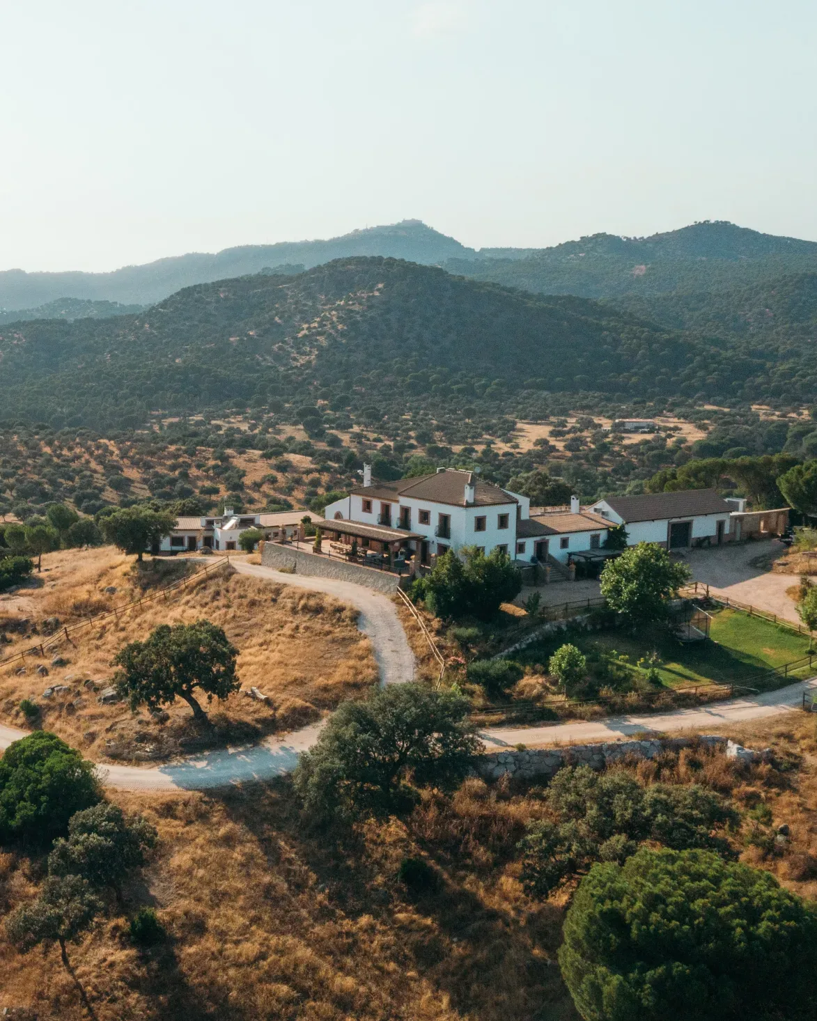 Finca El Encinarejo from the air — the lodge and its dehesa amid the mountains of the Sierra de Andújar