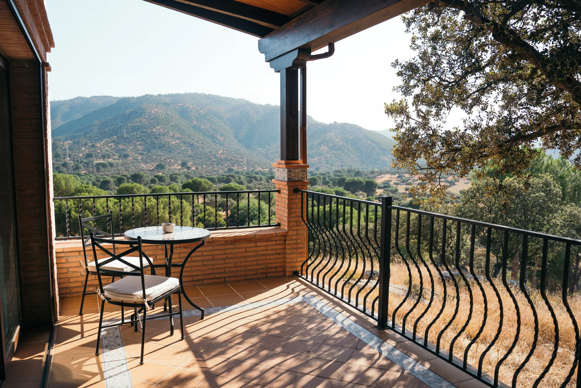 A private balcony table at golden hour, sierra ridgelines beyond
