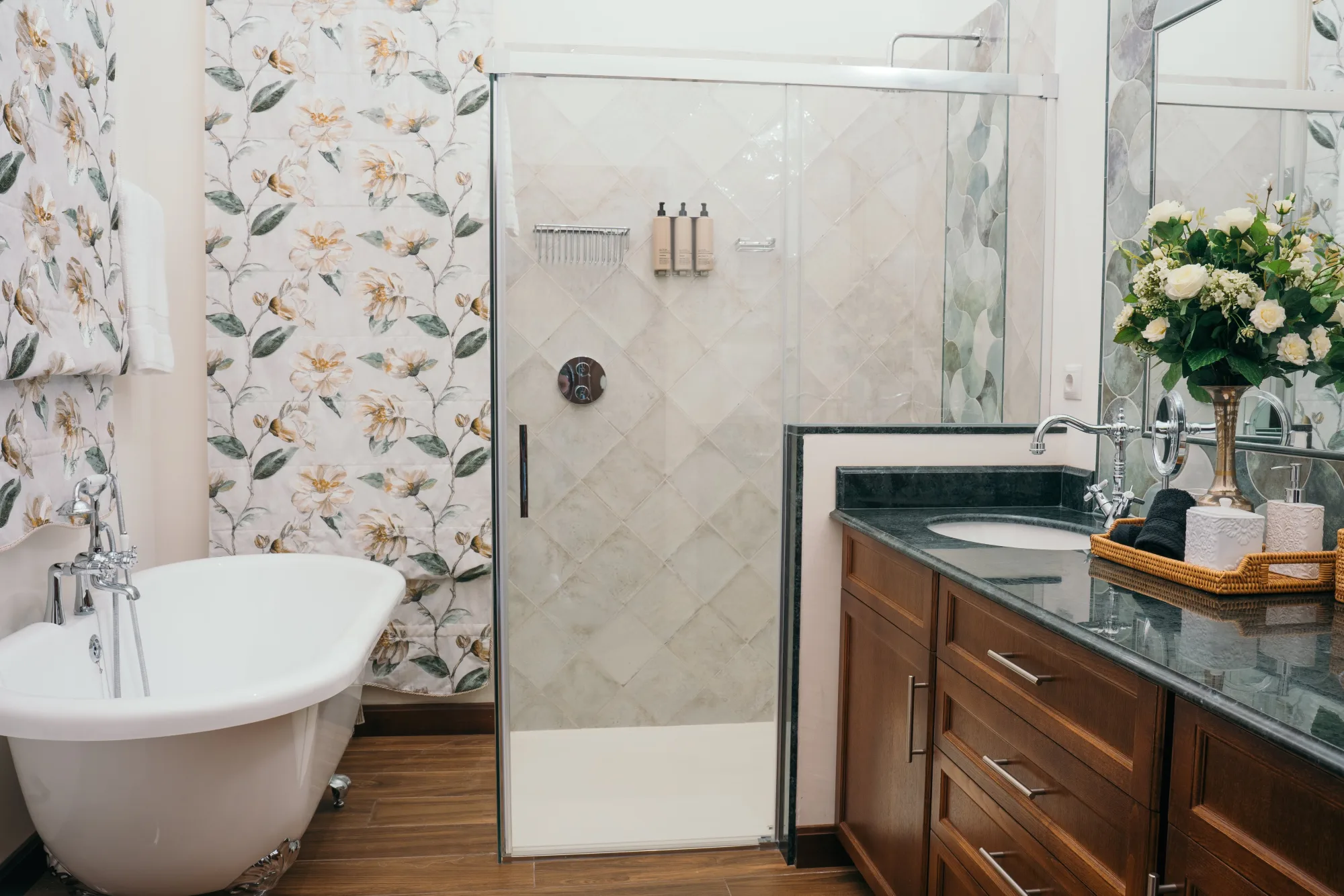 A lodge bathroom with a walk-in shower, clawfoot tub and marble counter