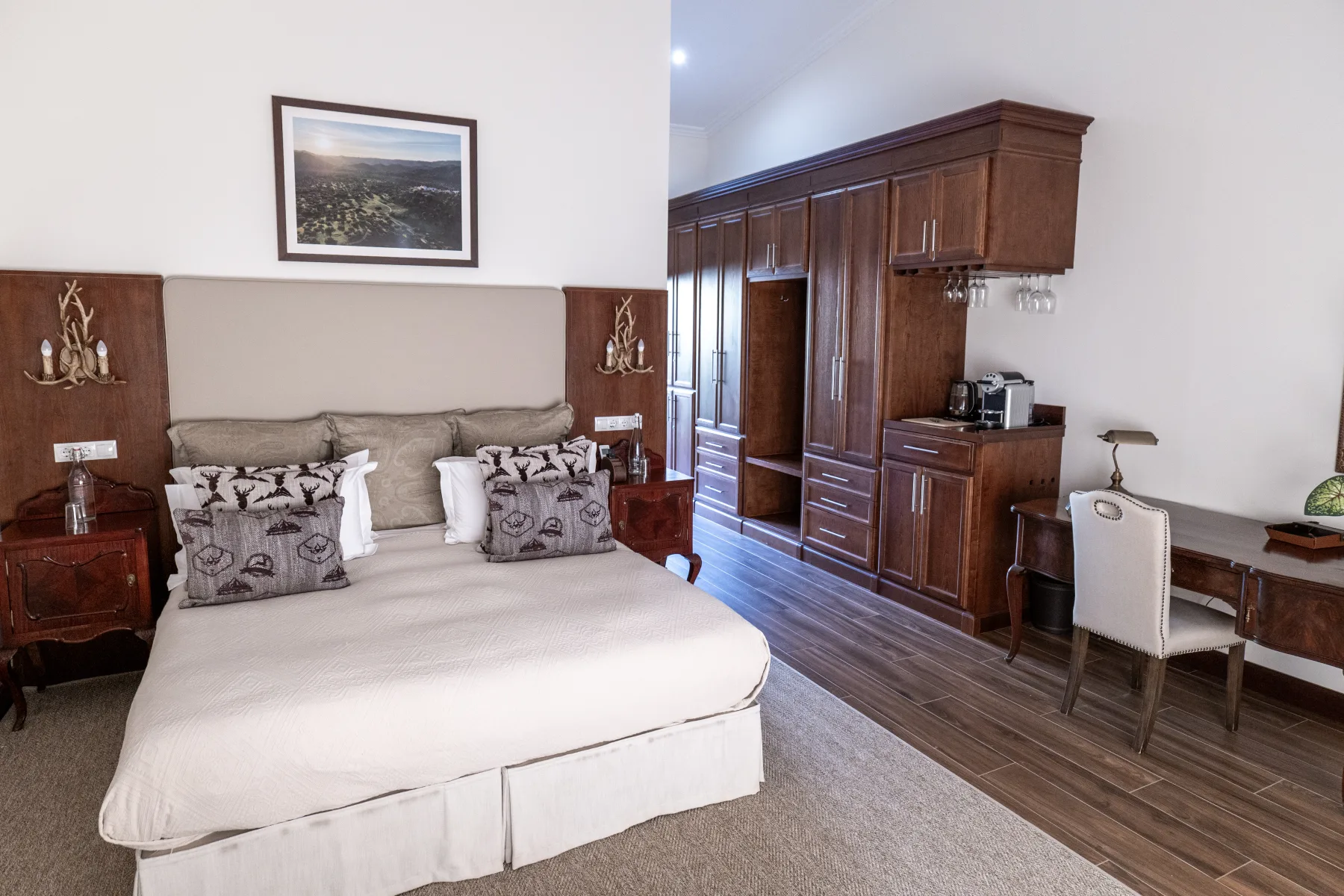 A lodge bedroom with its writing desk and fitted wardrobes