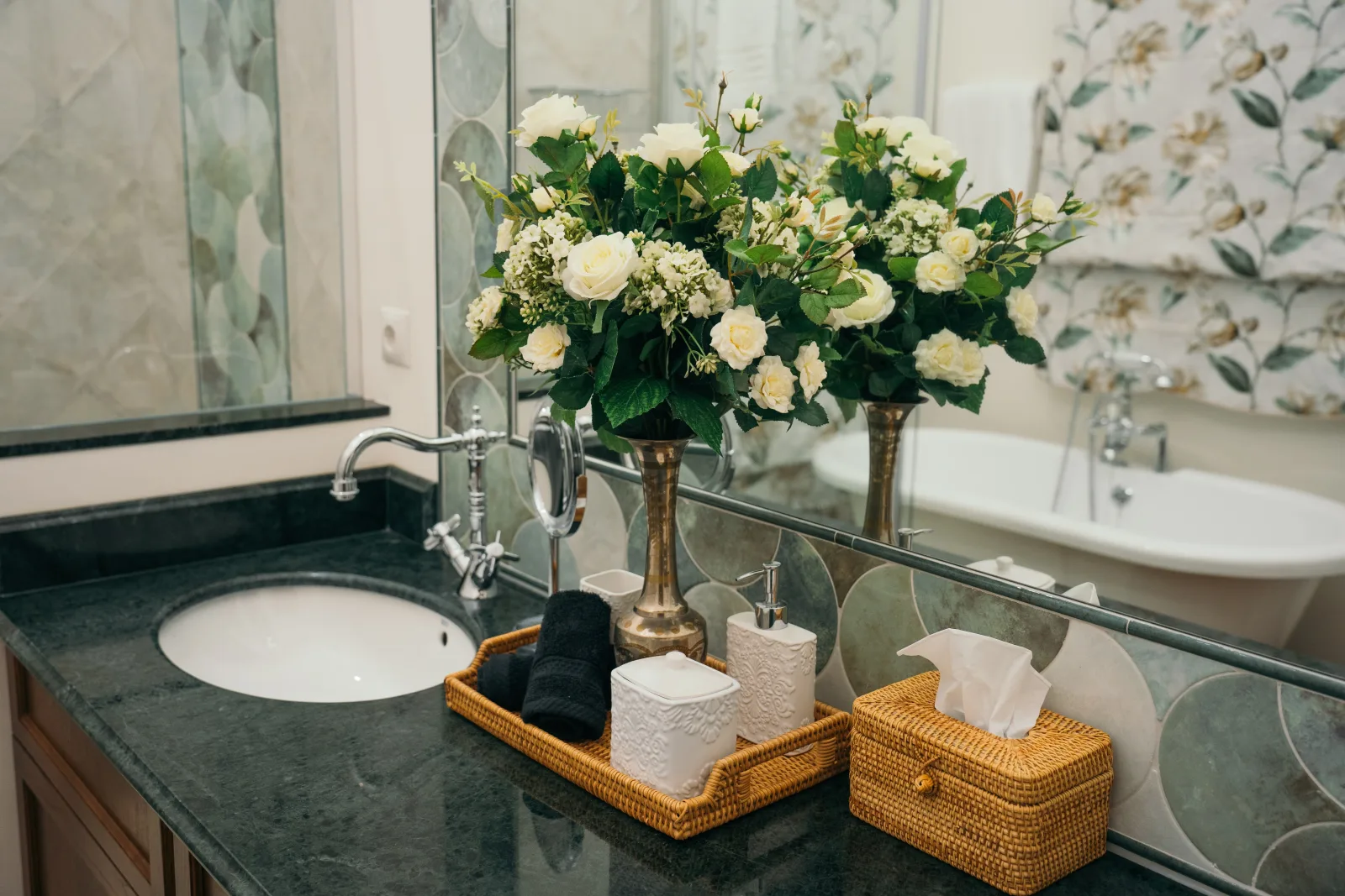 A lodge bathroom counter dressed with fresh white roses