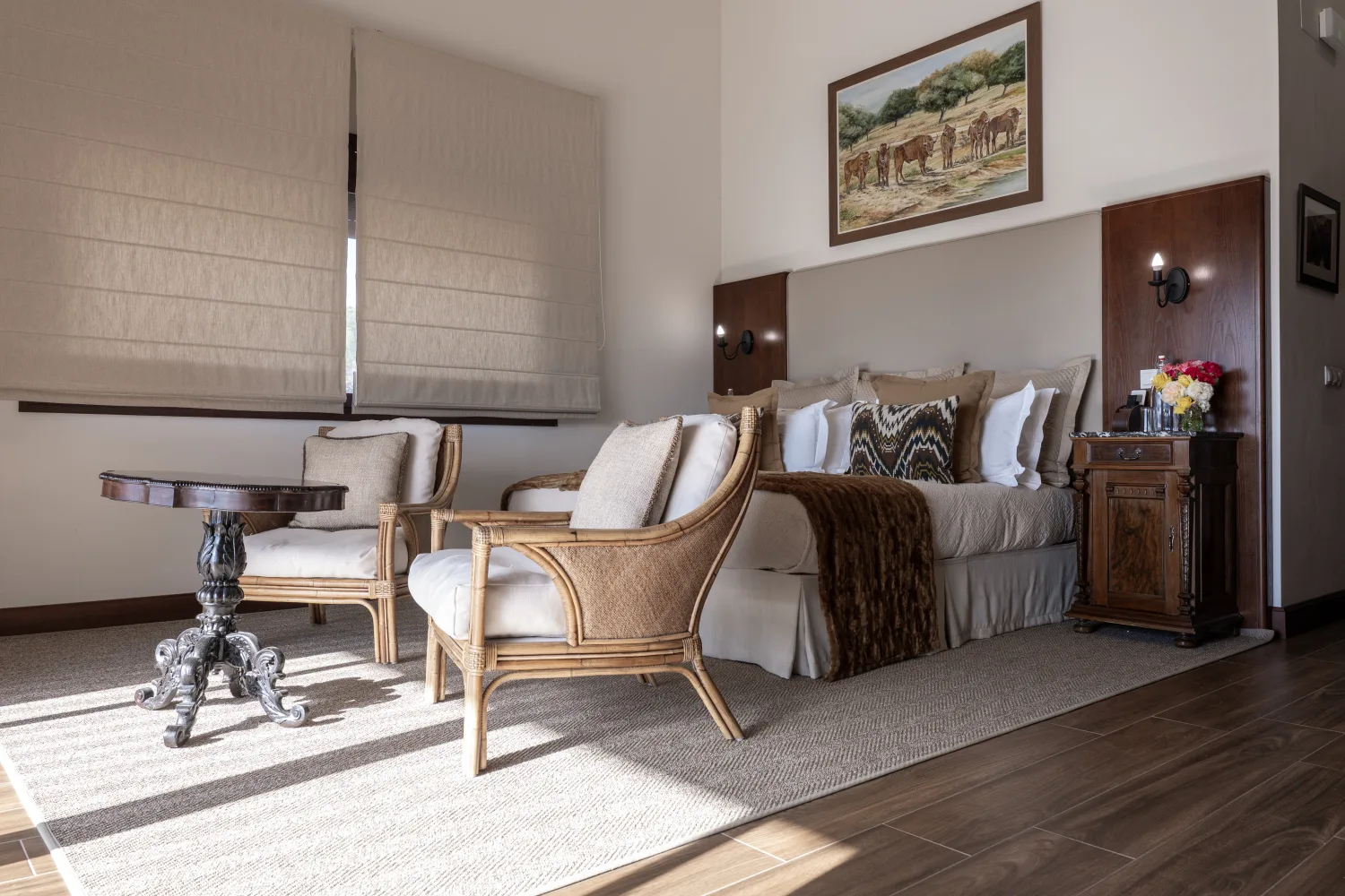 The Flores bedroom's sitting corner, rattan chairs pulled up to the window light