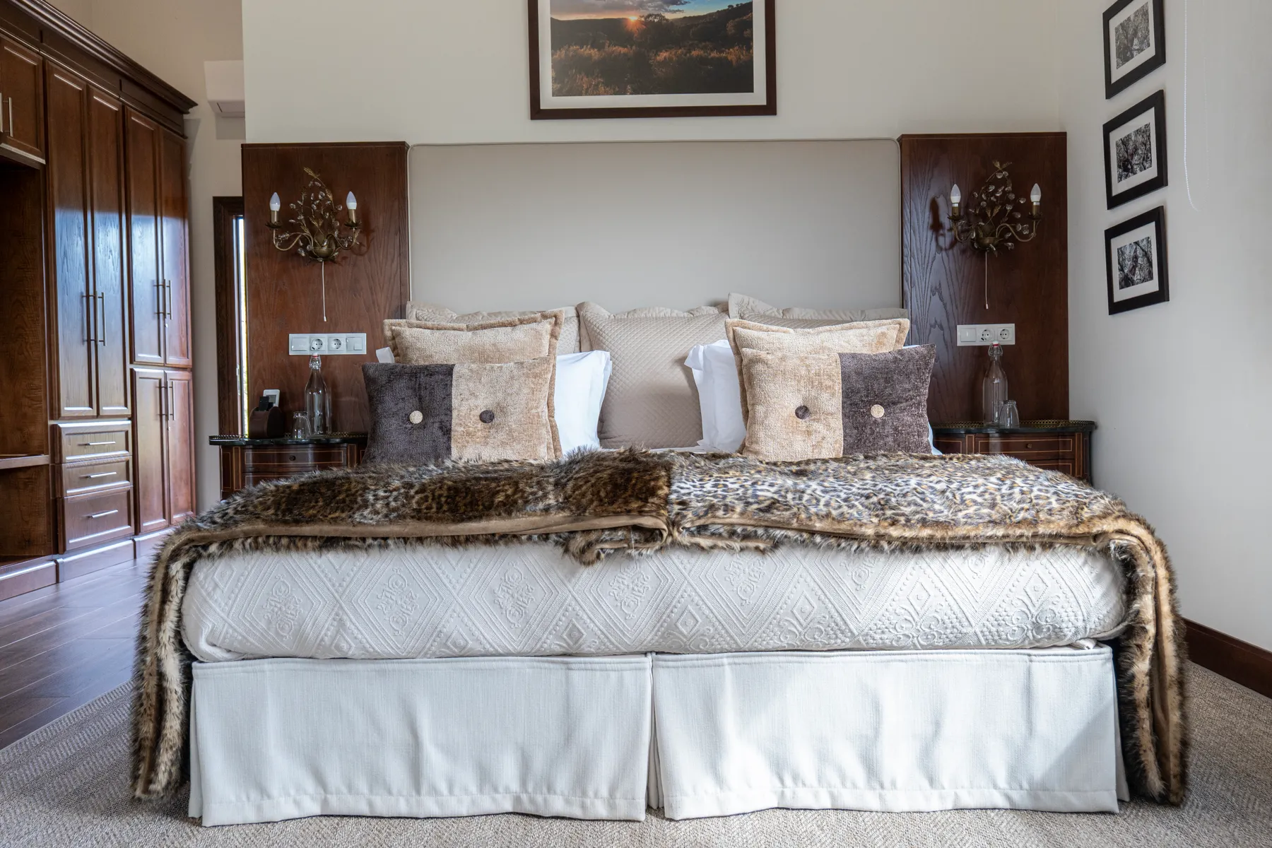 The Leopardo bedroom — a fur throw across the bed, cabinetry in dark wood