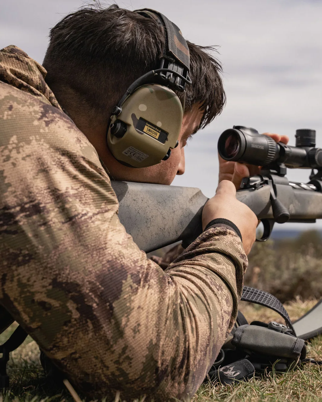 A hunter taking a careful, fair-chase shot from the prone position in the Spanish mountains