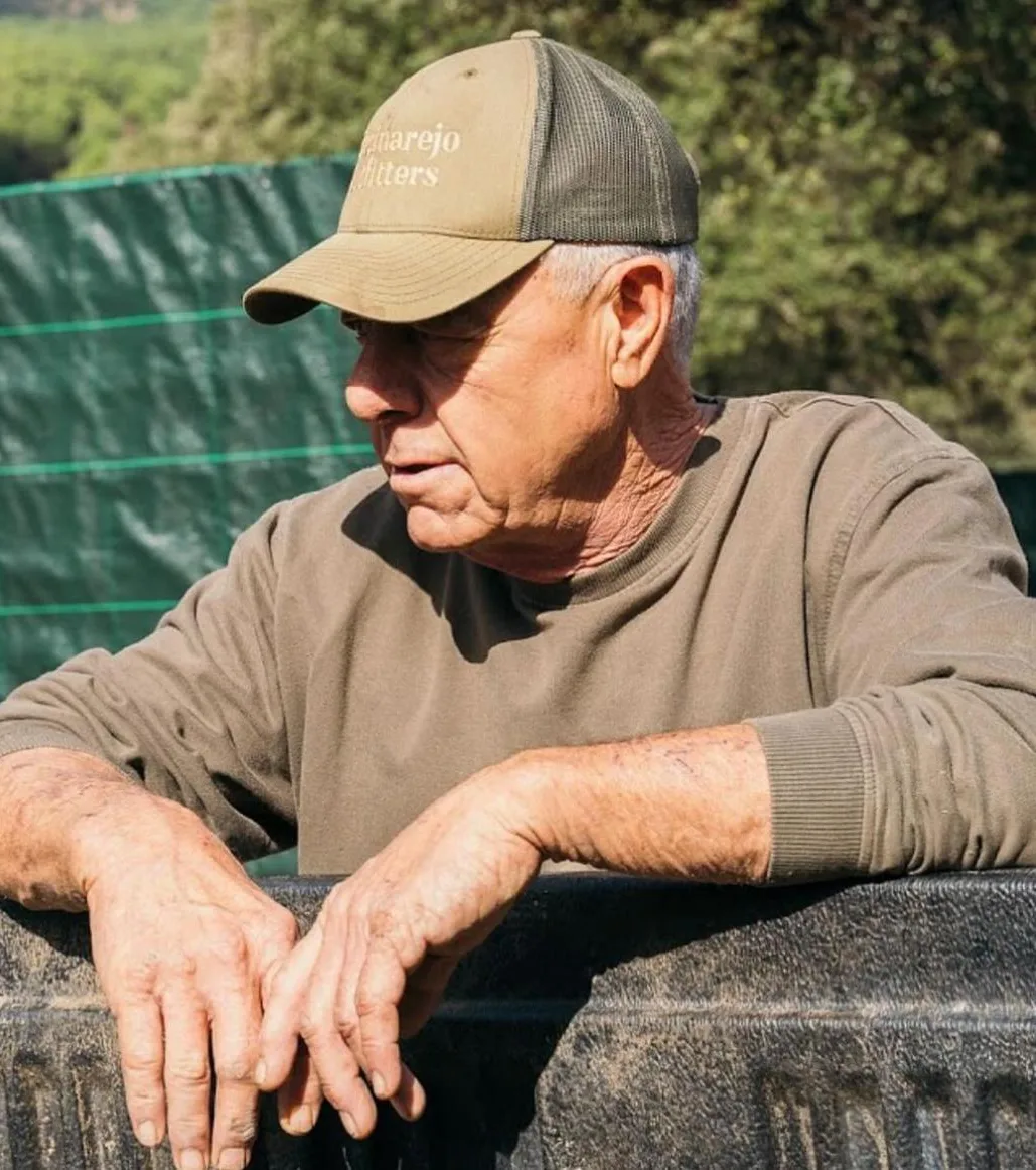 Guy Murdoch, Jess’s father, on the finca in an Encinarejo Outfitters cap
