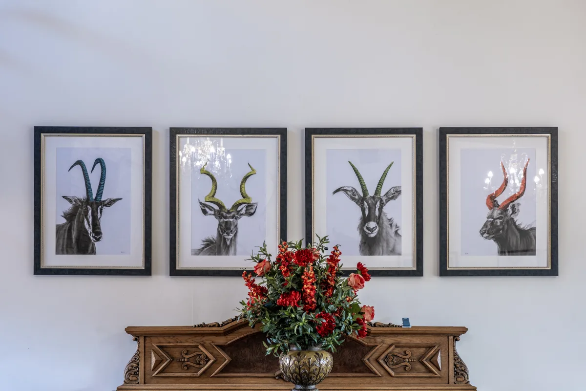 Hand-drawn game studies above the lodge sideboard